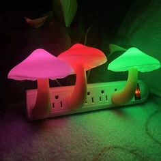 three mushroom shaped lights sitting on top of a power strip