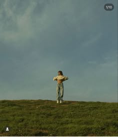 a man standing on top of a lush green field