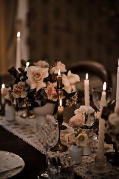 a table topped with lots of candles and flowers