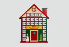 a wooden christmas house with a clock on the front and calendars on the side