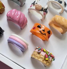 there are many different types of doughnuts on the counter top, including one with eyes and mouth