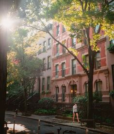 a person walking down the street in front of some buildings