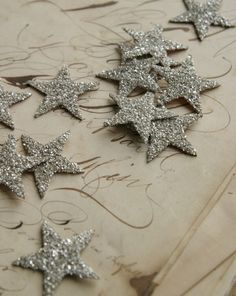 several silver stars are laying on a table