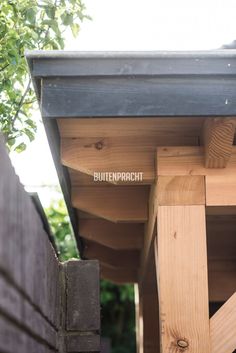 a wooden structure with the word butterpick written on it's side and trees in the background