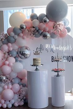 balloons and cake on display in front of a sign for an all - white bridal show