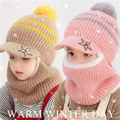 two children wearing hats and scarves in the snow with one pointing at the camera