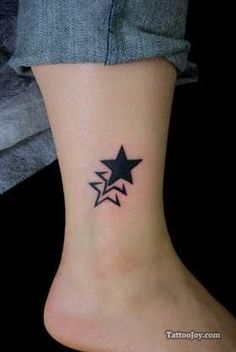 a small star tattoo on the ankle