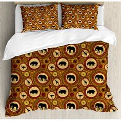 an elephant and giraffe pattern on a bed