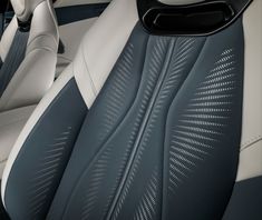 the interior of a car with blue and white leather