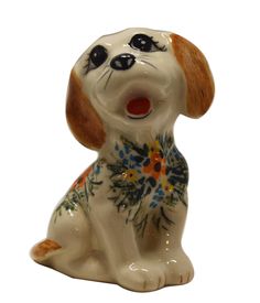 a ceramic figurine of a dog with flowers on it