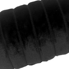 a roll of black velvet cord on a white background