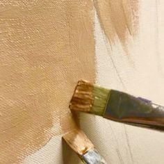 a paintbrush is being used to paint a wall