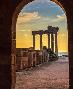 an arch leading into the distance with columns in it