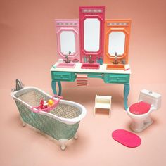 a doll house bathroom with sink, toilet and bathtub in the middle of it