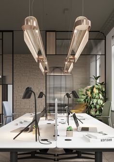 an office desk with three lamps hanging over it