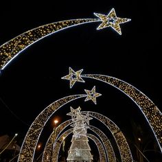 an arch decorated with christmas lights and stars