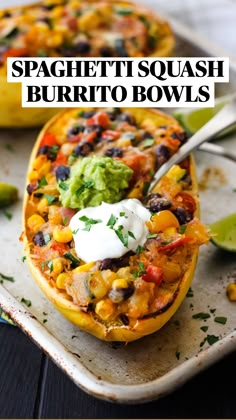 two stuffed sweet potatoes with guacamole, sour cream and salsa on top