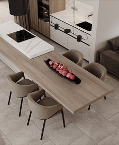 a table with some food on it in the middle of a living room and kitchen