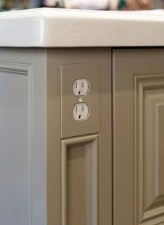 an electrical outlet on the side of a cabinet