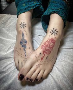 two people with tattoos on their feet and one has a snake, dragon, and star tattoo