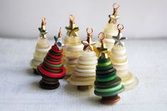 small wooden christmas trees are lined up on a table