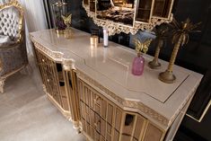 an ornately decorated dresser and mirror in a room