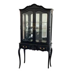 a black china cabinet with glass doors and drawers