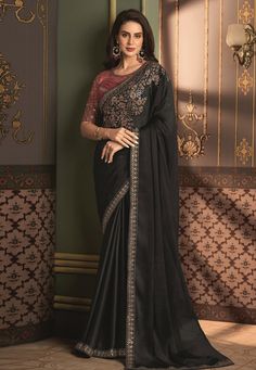 Drape yourself in elegance with our exquisite black chiffon saree, delicately crafted for the sophisticated wardrobe. The saree's lightweight fabric is perfect for any season, allowing for graceful movements and a stunning silhouette. Adorned with intricate embroidery and a shimmering border, this saree embodies the perfect blend of traditional design and modern flair. Its rich hue is a tribute to timeless fashion, making it an ideal choice for weddings, festivities, or a stylish day out. Indulg Black Embroidered Pre-draped Saree For Navratri, Festive Black Embroidered Pre-draped Saree, Semi-stitched Black Art Silk Blouse Piece, Elegant Pre-draped Saree With Embroidered Border, Black Silk Pre-draped Saree For Eid, Black Georgette Pre-draped Saree With Resham Embroidery, Black Pre-draped Saree With Resham Embroidery, Evening Embroidered Semi-stitched Saree, Elegant Embroidered Black Pre-draped Saree