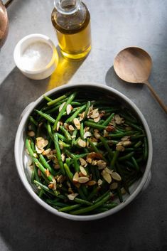 a bowl filled with green beans and nuts