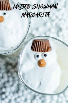 two glasses filled with whipped cream and decorated like snowmen