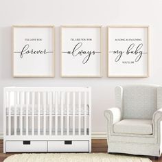 three framed posters on the wall above a crib in a baby's room