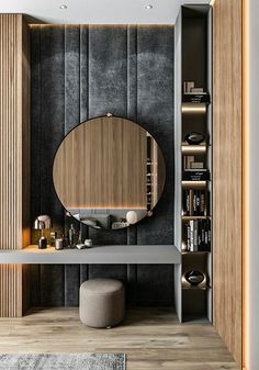 a room with a round mirror, stool and bookshelf on the wall next to it