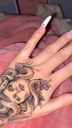 a woman's hand with tattoos on it