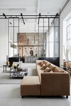 a living room filled with furniture and windows