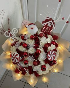 a christmas wreath with white and red decorations