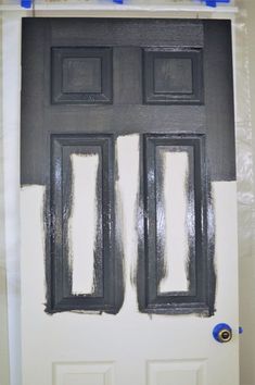 the door is painted black and white with some blue tape on it's sides