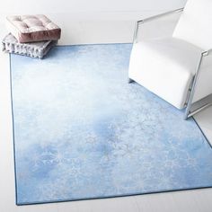 a white chair sitting on top of a blue rug