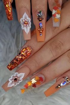 Decorative autumn-themed acrylic nails with rhinestones, glitter, and floral designs in orange and white tones. Fake Acrylic Nails, Ballet Nails, Long Press On Nails, Nagel Tips, Coffin Press On Nails, Orange Glitter, Thanksgiving Nails, Stick On Nails