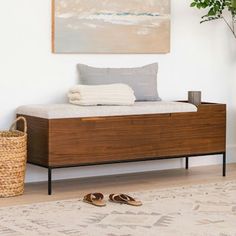 a bed sitting on top of a wooden dresser next to a potted plant