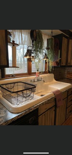 a kitchen sink sitting under a window next to a counter