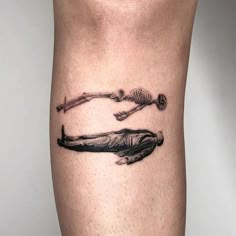 a tattoo on the leg of a person with skeleton bones and spoons in it