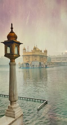 a clock tower sitting on the side of a body of water