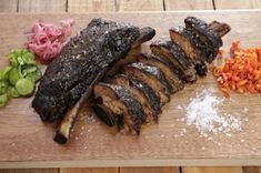 the steak is sliced up and ready to be served on the grill with some seasoning