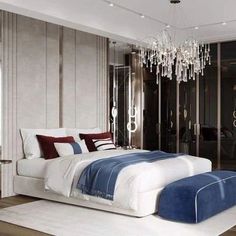 a bedroom with two beds and a chandelier hanging from the ceiling