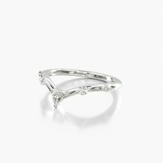 a white gold and diamond ring on a white background with the word love written in cursive writing