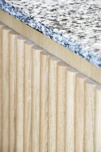 a close up view of a counter top with wood grained edges and blue speckles