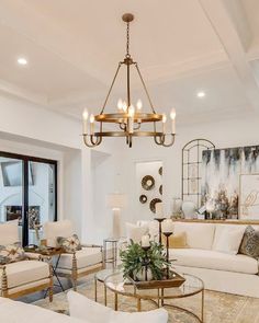 a living room filled with furniture and a chandelier