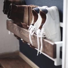 several pairs of shoes are lined up on a shelf