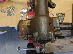 a close up of an old metal object on a workbench in a garage