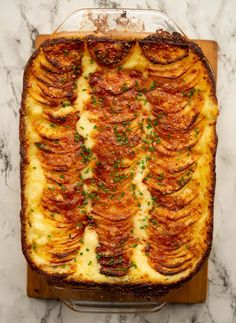 a casserole dish with potatoes and parsley